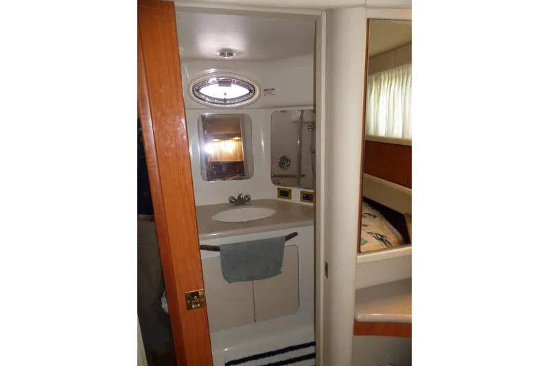 Slide: The Image of Bathroom interior of 2000 Sea Ray 380 Aft Cabin yacht, featuring sink and mirror. - 68