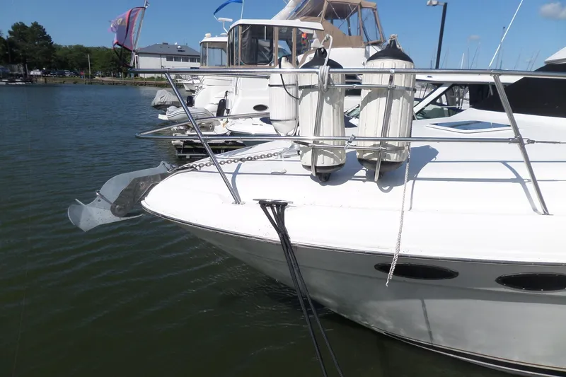 Slide: The Image of 2000 Sea Ray 380 Aft Cabin yacht docked at marina, featuring fenders and anchor. - 7