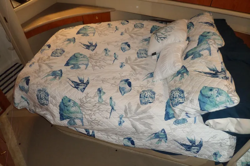 Slide: The Image of Cozy cabin bed in 2000 Sea Ray 380 Aft Cabin with marine-themed bedding. - 72