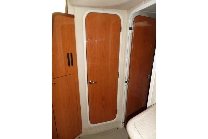 Slide: The Image of Interior of 2000 Sea Ray 380 Aft Cabin with wooden doors and cabinetry. - 80