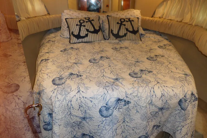 Slide: The Image of Nautical-themed bedroom in 2000 Sea Ray 380 Aft Cabin with anchor pillows and seashell quilt. - 82
