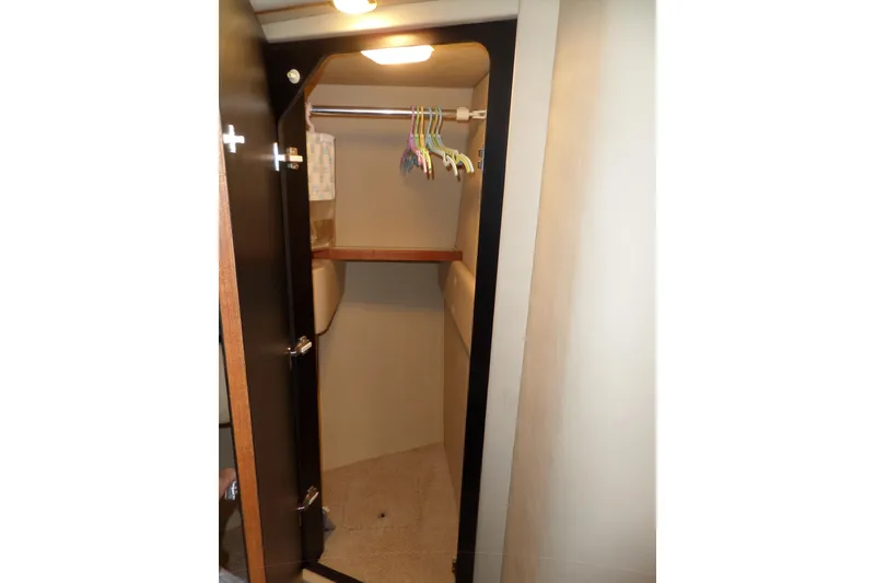 Slide: The Image of Closet interior on 2000 Sea Ray 380 Aft Cabin yacht with hangers and shelf. - 88