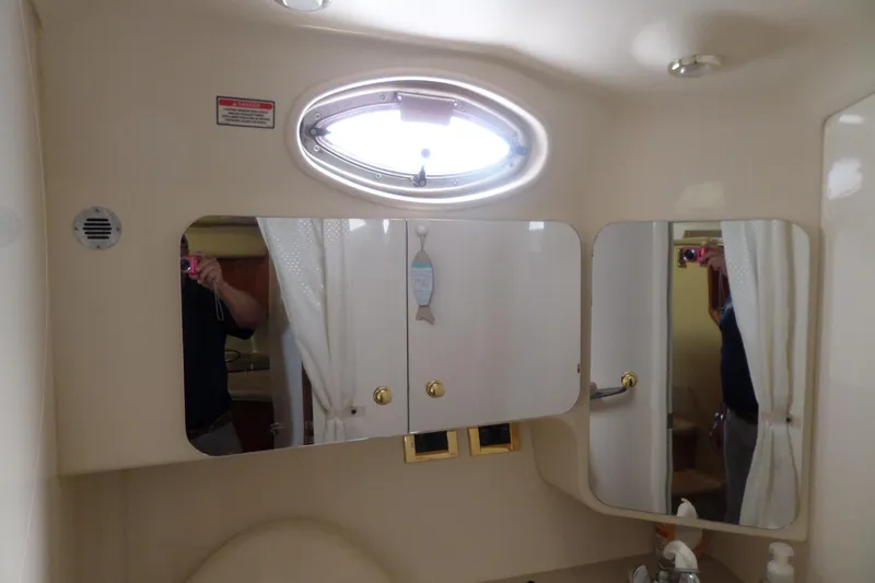 Slide: The Image of Bathroom interior of 2000 Sea Ray 380 Aft Cabin with mirrors and porthole window. - 93