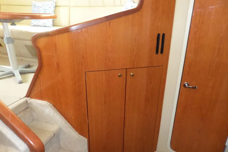 Slide: The Image of Interior of 2000 Sea Ray 380 Aft Cabin with wooden paneling and stairs. - 96