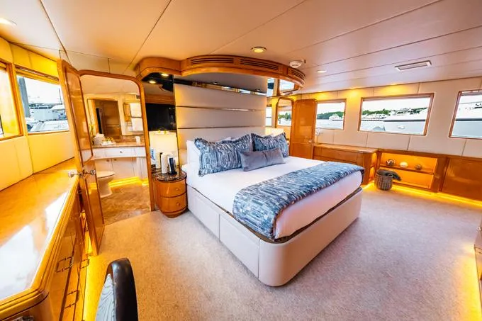 Slide: The Image of Luxurious 1995 Hatteras Motor Yacht bedroom with elegant lighting and modern decor. - 12