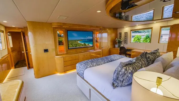 Slide: The Image of Luxurious 1995 Hatteras Motor Yacht bedroom with elegant wood finishes and scenic views. - 15