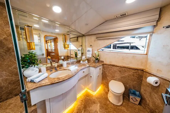 Slide: The Image of Luxurious bathroom in a 1995 Hatteras Motor Yacht with marble accents and elegant lighting. - 16