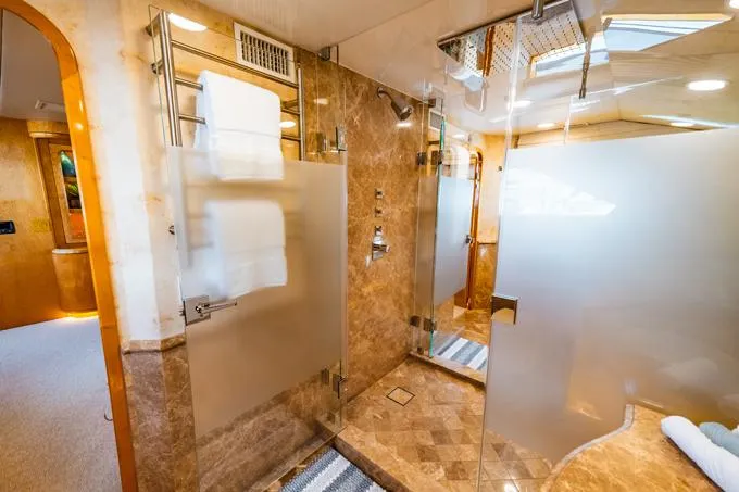 Slide: The Image of Luxurious bathroom in 1995 Hatteras Motor Yacht with glass shower and marble accents. - 17