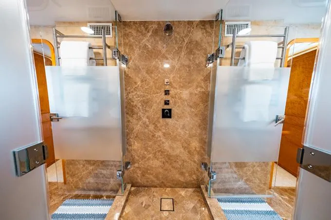 Slide: The Image of Luxurious bathroom in 1995 Hatteras Motor Yacht with marble and frosted glass accents. - 18