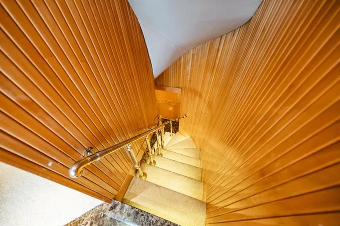 Slide: The Image of Interior staircase of 1995 Hatteras Motor Yacht with wooden paneling and metal handrail. - 20