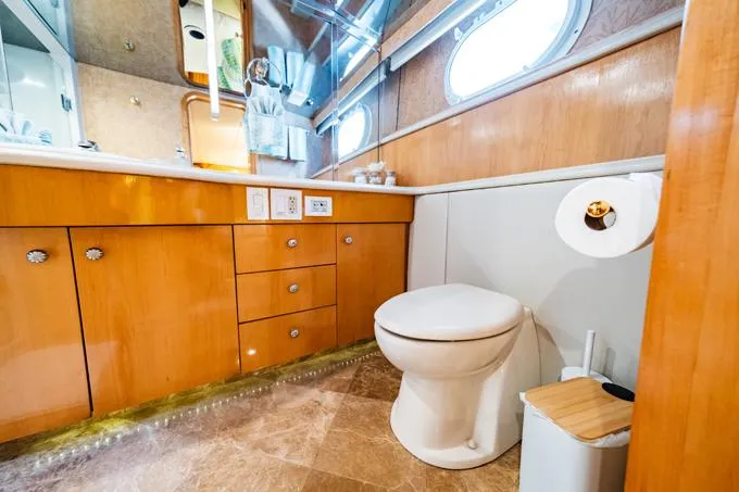 Slide: The Image of Luxurious bathroom in 1995 Hatteras Motor Yacht with wooden cabinetry and modern fixtures. - 26