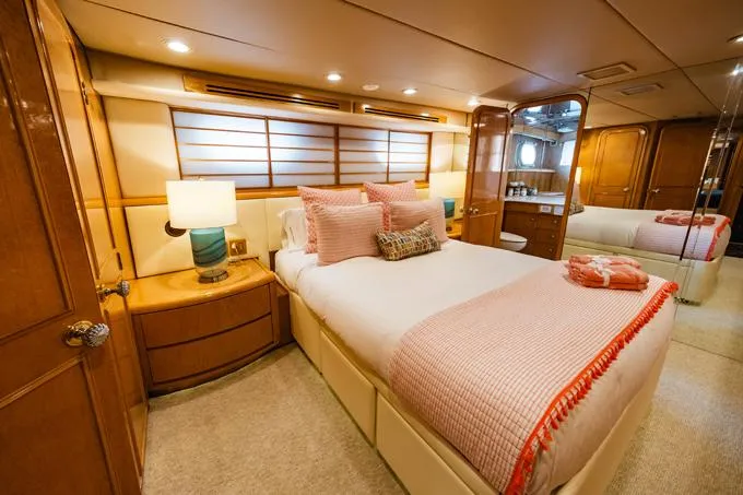 Slide: The Image of Luxurious 1995 Hatteras Motor Yacht bedroom with elegant decor and cozy bedding. - 30