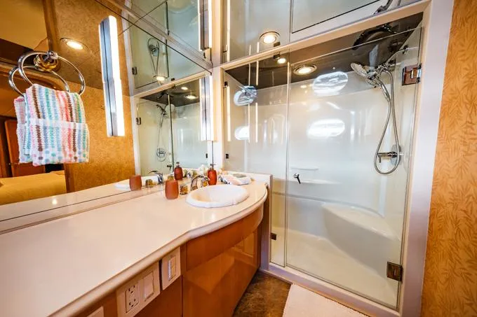 Slide: The Image of Luxurious bathroom in a 1995 Hatteras Motor Yacht with glass shower and modern fixtures. - 31