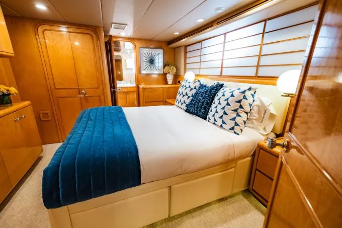 Slide: The Image of Luxurious 1995 Hatteras Motor Yacht bedroom with elegant decor and cozy bedding. - 33
