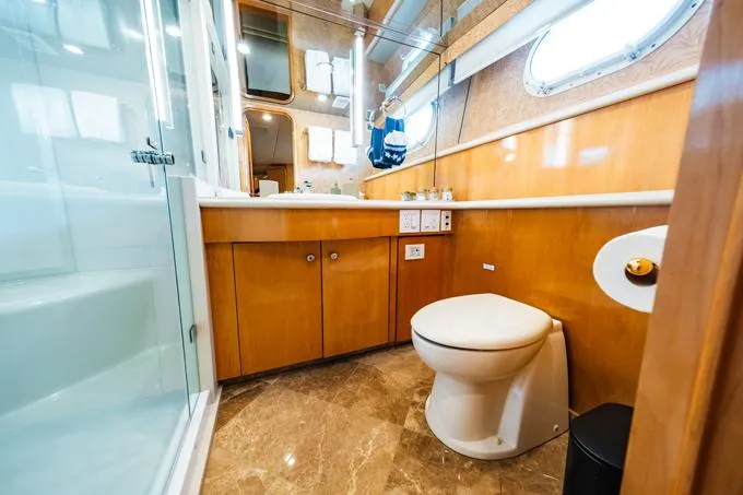 Slide: The Image of Luxurious 1995 Hatteras Motor Yacht bathroom with wood cabinetry and marble flooring. - 35