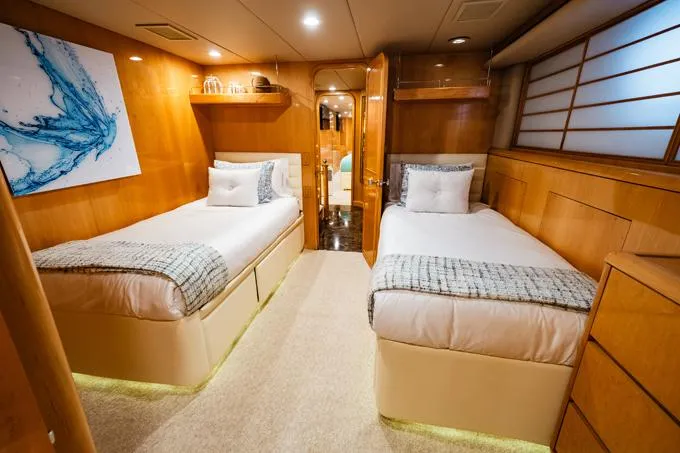Slide: The Image of Luxurious 1995 Hatteras Motor Yacht cabin with twin beds and elegant wood paneling. - 38