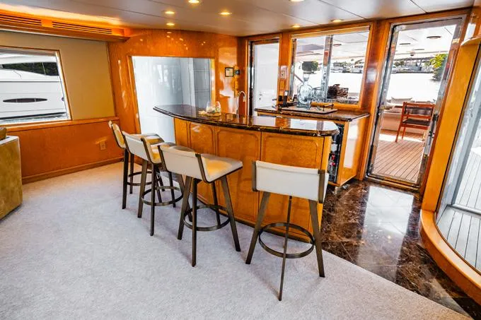 Slide: The Image of Luxurious 1995 Hatteras Motor Yacht interior with bar and seating area. - 6