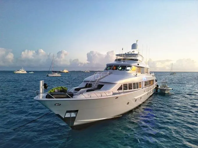 Slide: The Image of Luxurious 1995 Hatteras Motor Yacht anchored in serene ocean waters. - 109