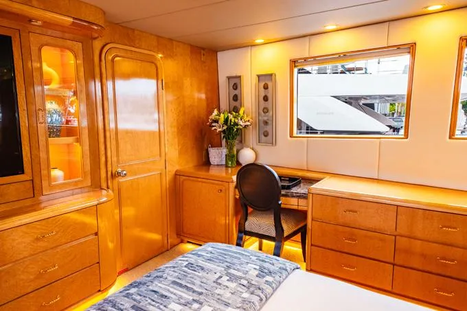 Slide: The Image of Luxurious 1995 Hatteras Motor Yacht interior with elegant wood furnishings and natural light. - 14