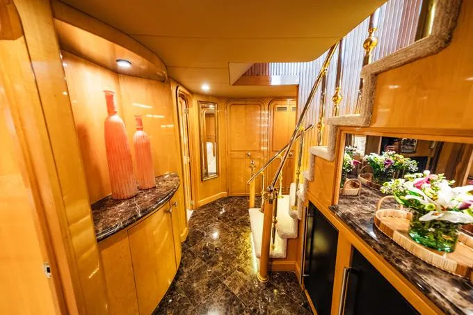 Slide: The Image of Luxurious interior of a 1995 Hatteras Motor Yacht with elegant wood finishes and marble flooring. - 21