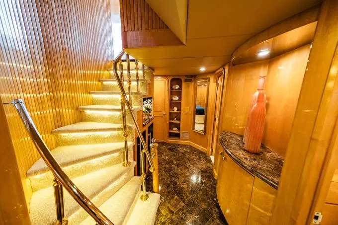 Slide: The Image of Luxurious interior of a 1995 Hatteras Motor Yacht with elegant staircase and wood paneling. - 22