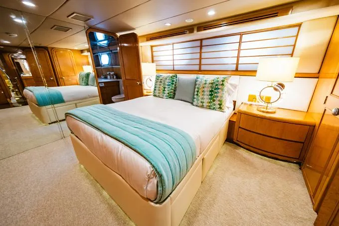 Slide: The Image of Luxurious bedroom interior of a 1995 Hatteras Motor Yacht with elegant decor. - 23