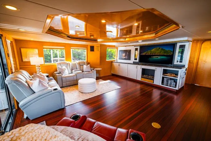 Slide: The Image of Luxurious 1995 Hatteras Motor Yacht interior with elegant wood flooring and plush seating. - 42