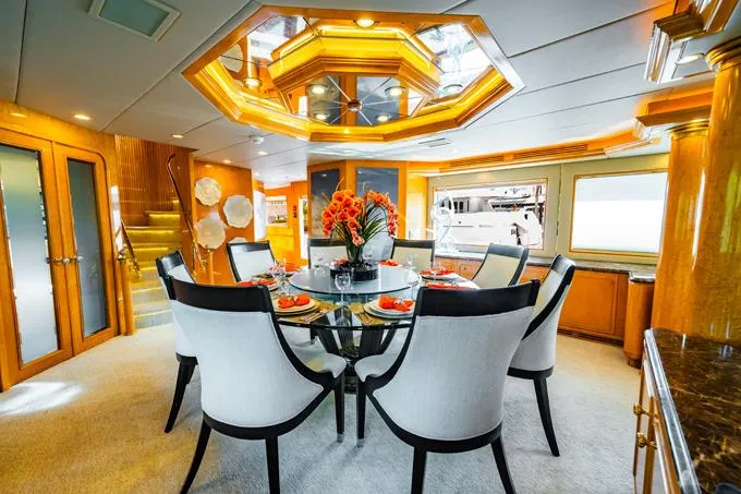 Slide: The Image of Luxurious dining area in a 1995 Hatteras Motor Yacht with elegant decor. - 7