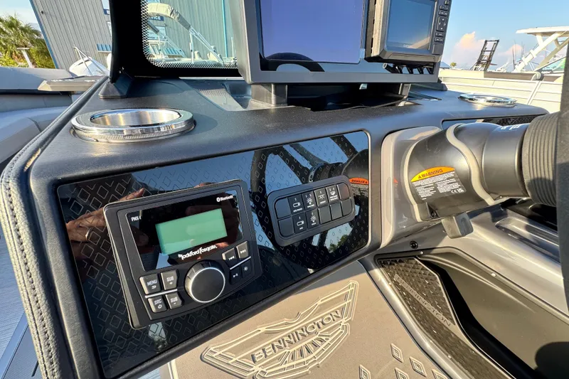 Slide: The Image of 2026 Bennington 24 MSB boat dashboard with modern controls and display. - 13