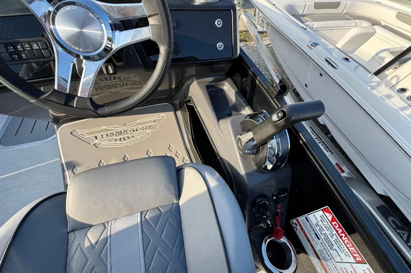 Slide: The Image of 2026 Bennington 24 MSB boat interior with steering wheel and control panel. - 15