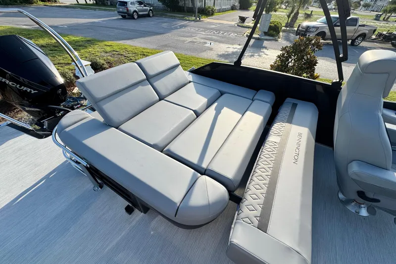 Slide: The Image of 2026 Bennington 24 MSB boat with luxurious gray seating and Mercury engine. - 19