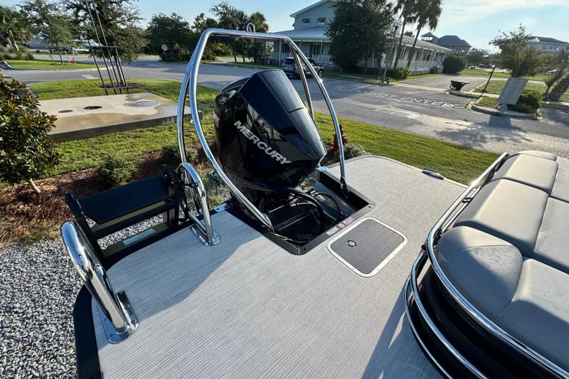 Slide: The Image of 2026 Bennington 24 MSB boat with Mercury engine, docked in a sunny marina setting. - 21