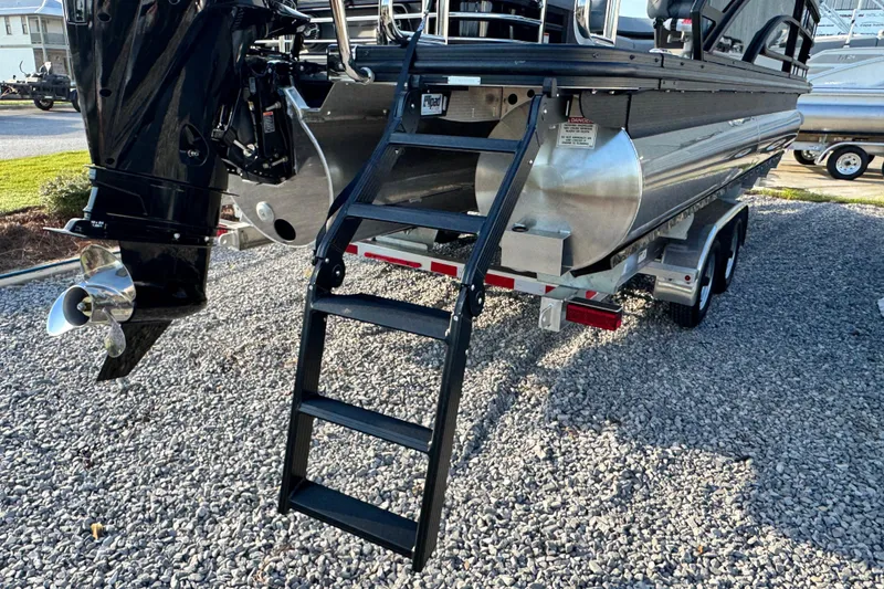 Slide: The Image of 2026 Bennington 24 MSB boat on trailer with ladder and outboard motor. - 25