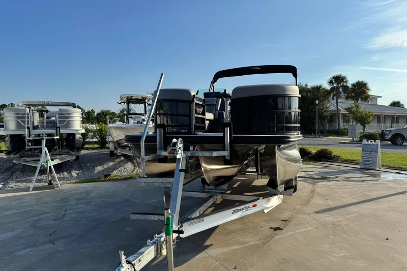 Slide: The Image of 2026 Bennington 24 MSB pontoon boat on trailer, sunny outdoor setting. - 5