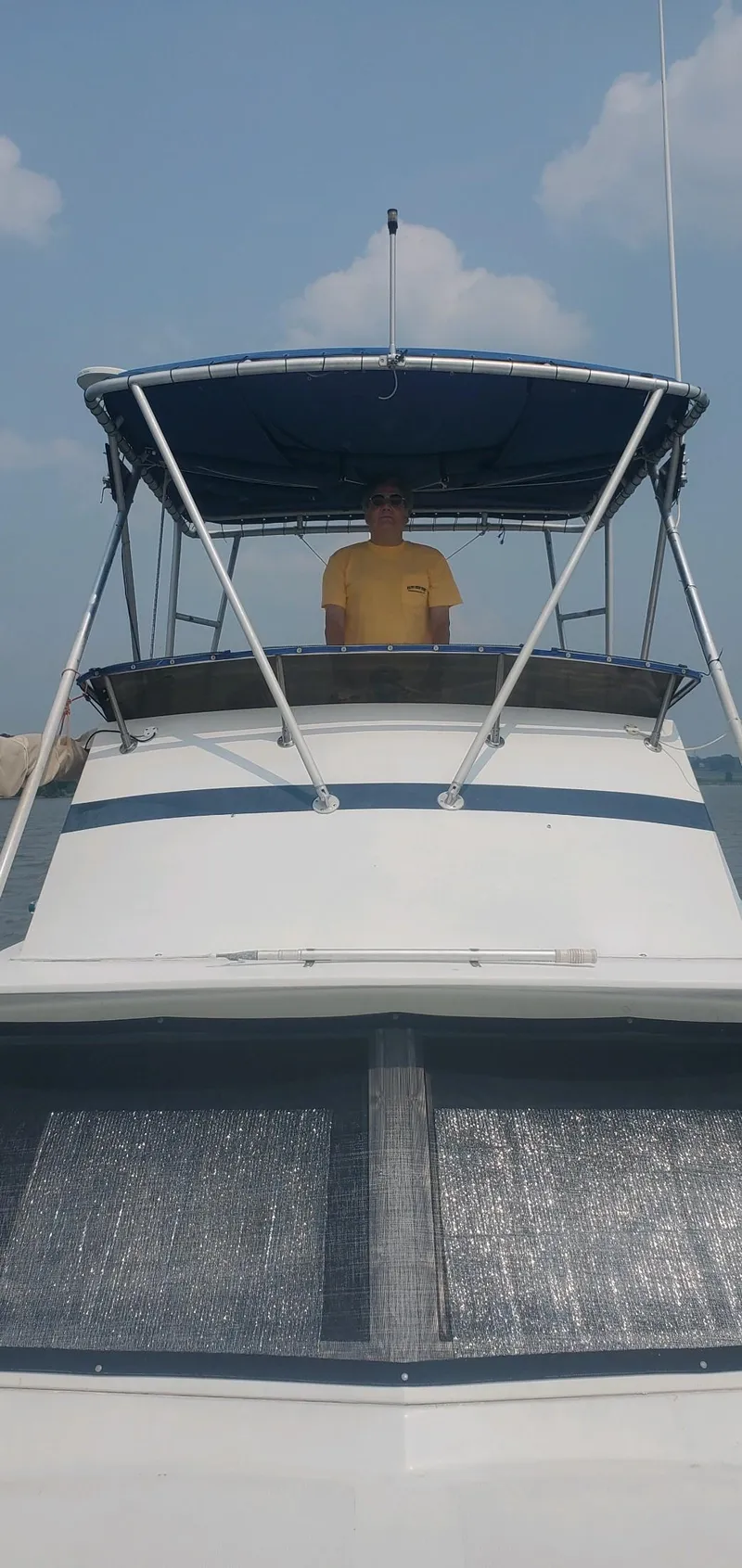 Slide: The Image of Man on 1977 Pequod 34 Sportfish boat under blue sky. - 12
