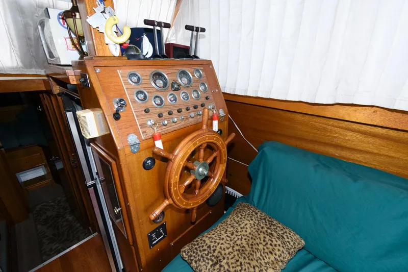 Slide: The Image of 1977 Pequod 34 Sportfish boat helm with wooden steering wheel and control panel. - 18
