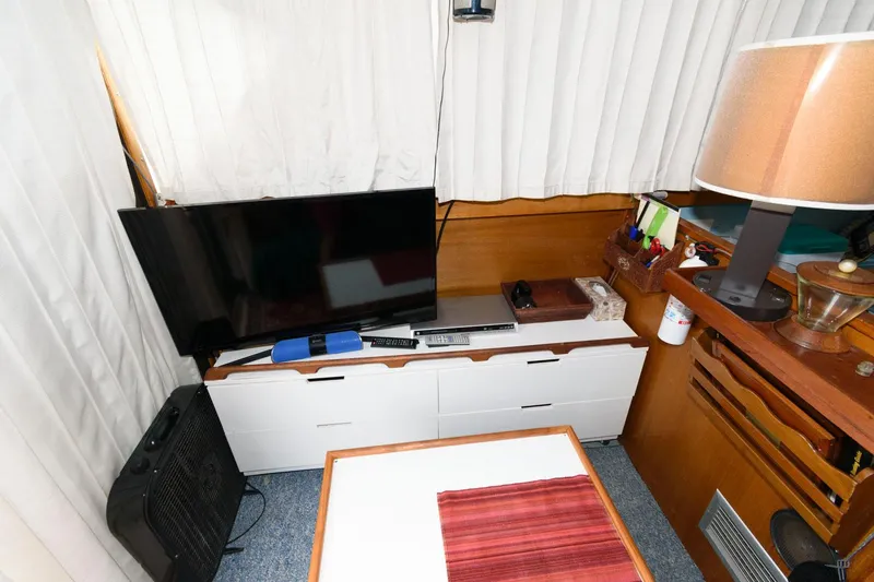 Slide: The Image of Interior of 1977 Pequod 34 Sportfish with TV, storage, and lamp. - 19