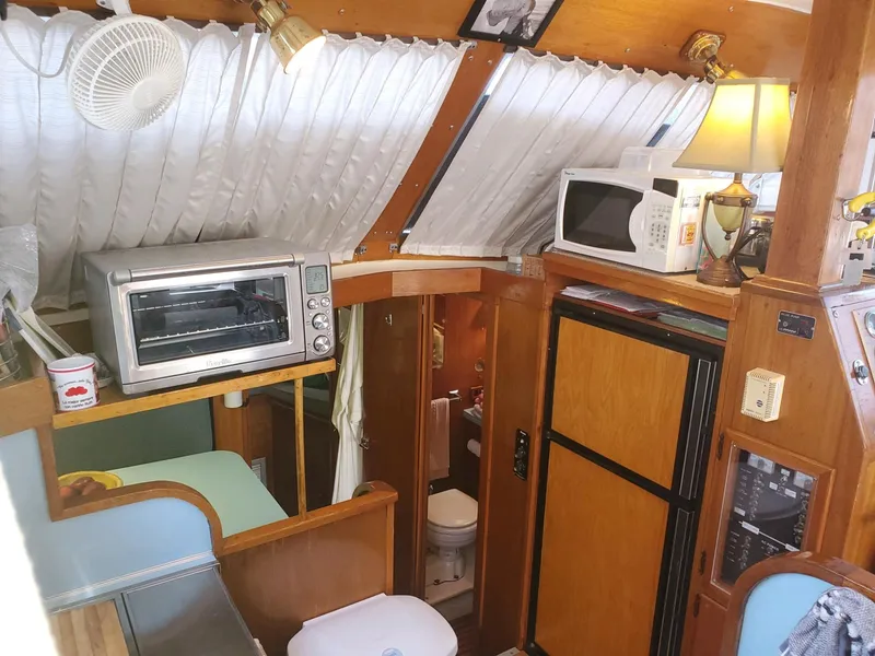 Slide: The Image of 1977 Pequod 34 Sportfish boat interior with kitchen appliances and bathroom. - 22