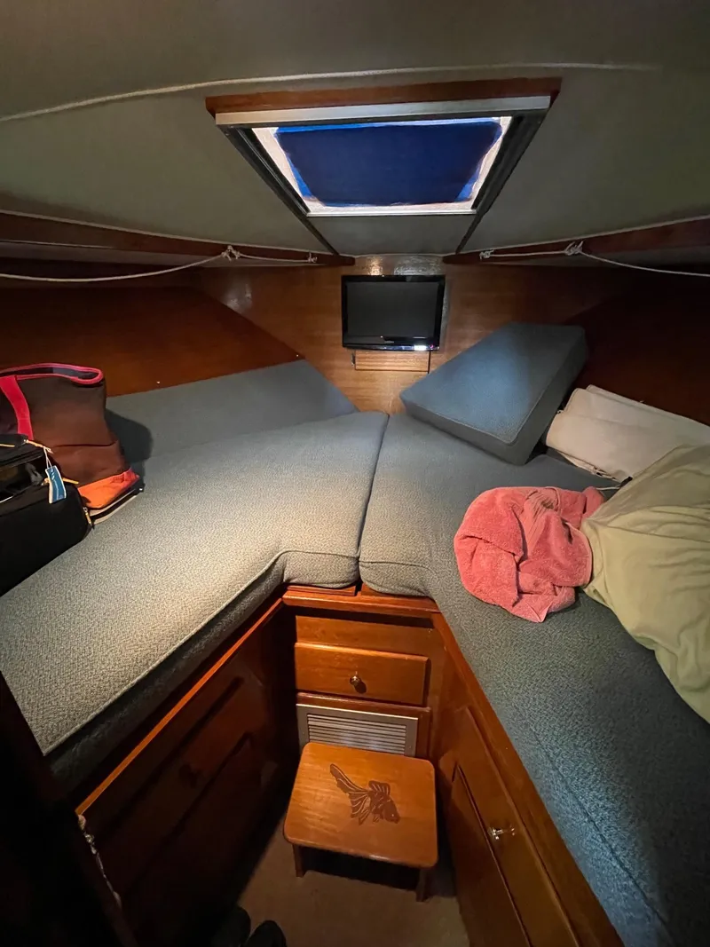 Slide: The Image of 1977 Pequod 34 Sportfish cabin interior with bed, storage, and skylight. - 34