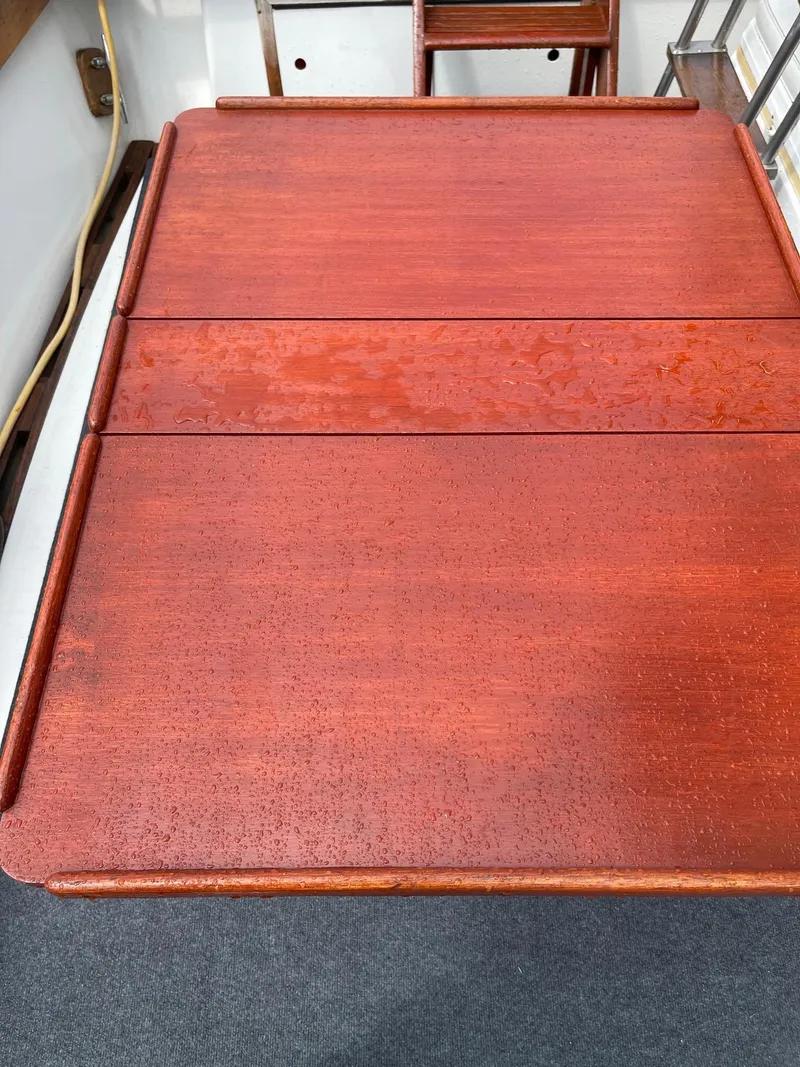 Slide: The Image of Wooden table on a 1977 Pequod 34 Sportfish boat. - 35