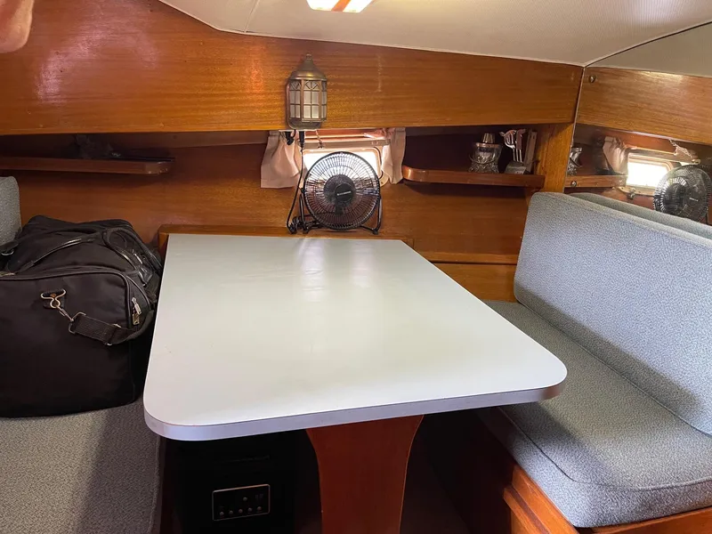 Slide: The Image of 1977 Pequod 34 Sportfish cabin interior with dining table and seating. - 36