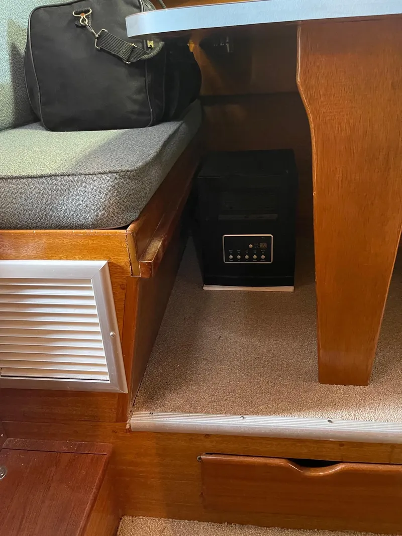 Slide: The Image of 1977 Pequod 34 Sportfish interior with seating and storage compartments. - 37