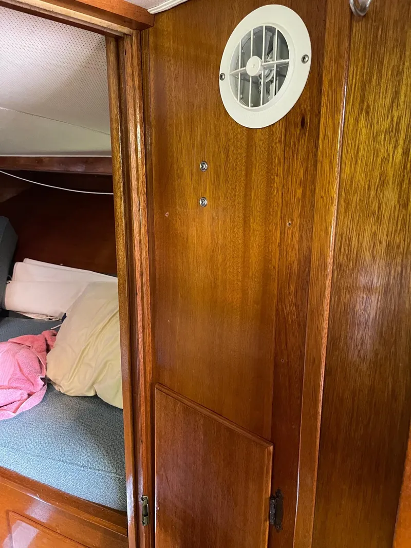 Slide: The Image of Interior cabin of 1977 Pequod 34 Sportfish boat with wooden paneling. - 40