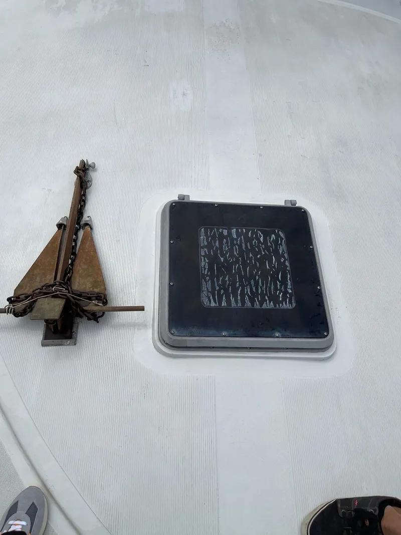 Slide: The Image of 1977 Pequod 34 Sportfish boat deck with anchor and hatch. - 6