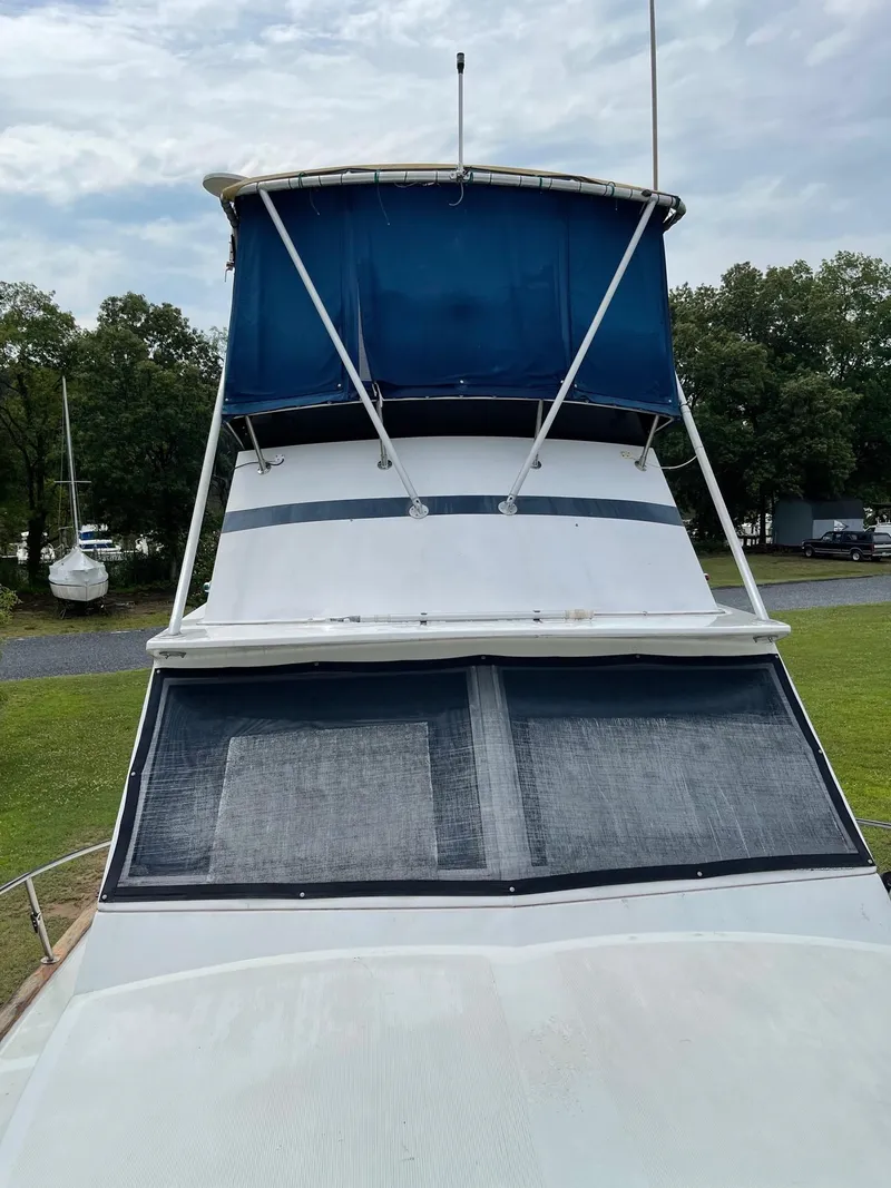 Slide: The Image of 1977 Pequod 34 Sportfish boat with blue canopy and windows. - 7