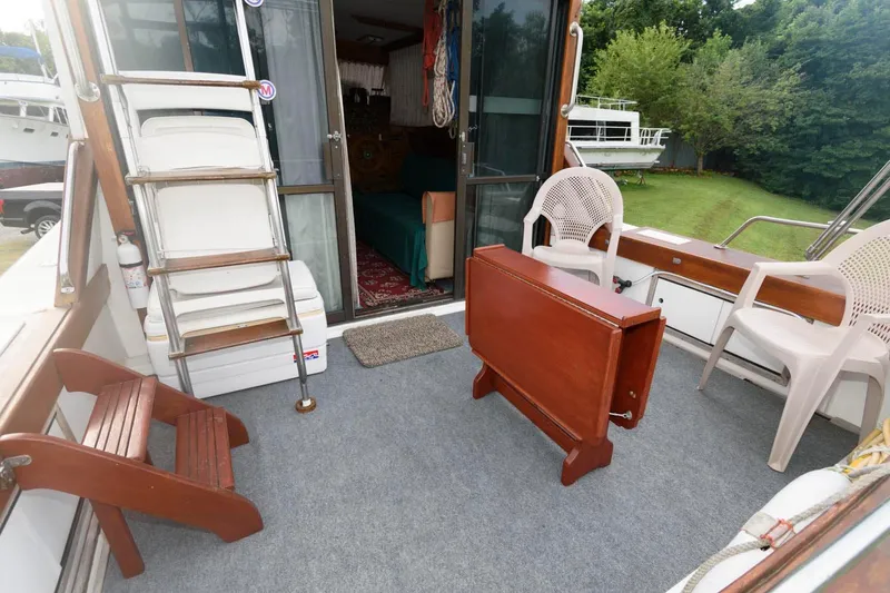 Slide: The Image of 1977 Pequod 34 Sportfish boat interior with chairs, table, and ladder. - 9