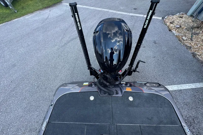 Slide: The Image of 2026 Skeeter ZXE20 boat with Minn Kota motor, parked on asphalt. - 18