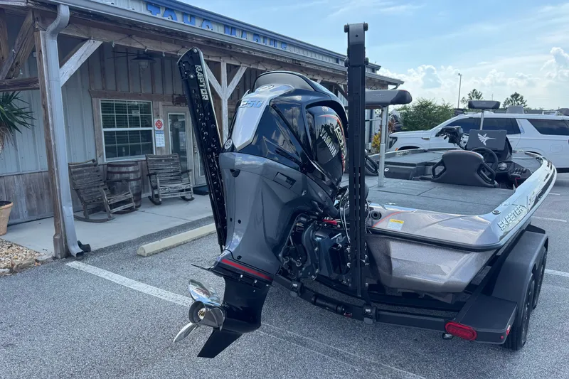 Slide: The Image of 2026 Skeeter ZXE20 boat with Yamaha engine parked outside a rustic building. - 19