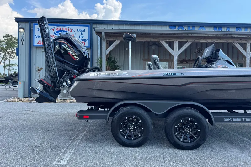 Slide: The Image of 2026 Skeeter ZXE20 boat on trailer outside marine service shop. - 4