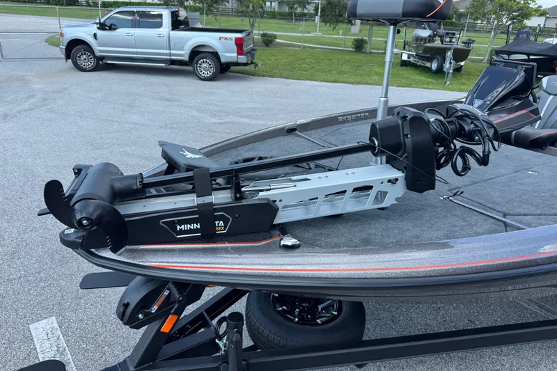Slide: The Image of 2026 Skeeter ZXE20 boat with Minn Kota trolling motor in parking lot. - 8
